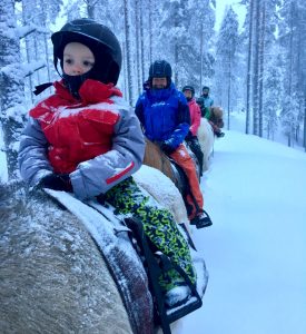 Horse Riding during Christmas in Ruka, Lapland for the best Family adventure travel in Europe
