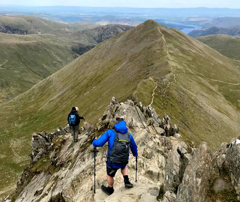 How to reduce knee pain when hiking: 17 tips for trekking with achy knees Hiking down from Helvellyn in the Lake District UK