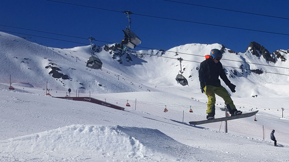 Snowboarding through Area 47 snowpark in Solden