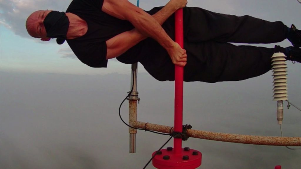 Extreme street workouts and rooftopping Human cross 250 meters image copyright of Petr Hulk