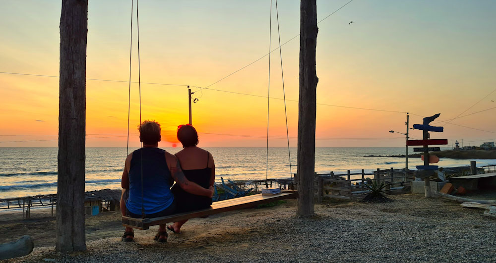 Patrick and Cara on Free Spirit Hostel swing at sunset
