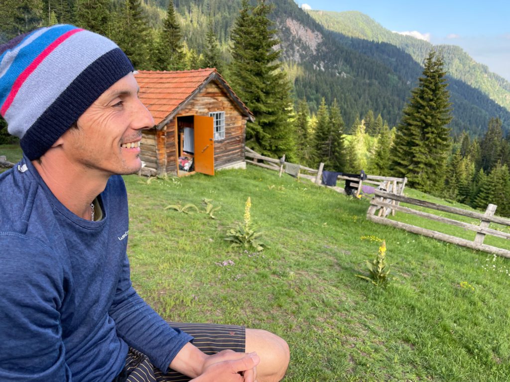 A hiker with mountain view wearing a merino accessory wool hat