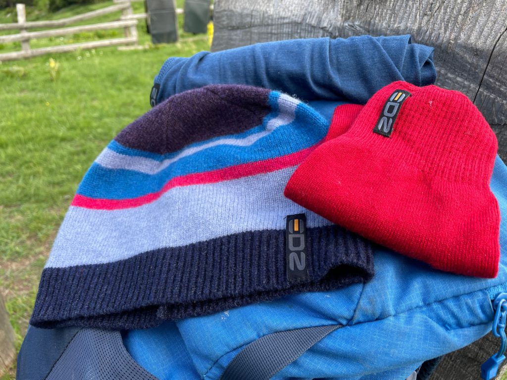 Merino winter hat and gloves sat on a rucksack
