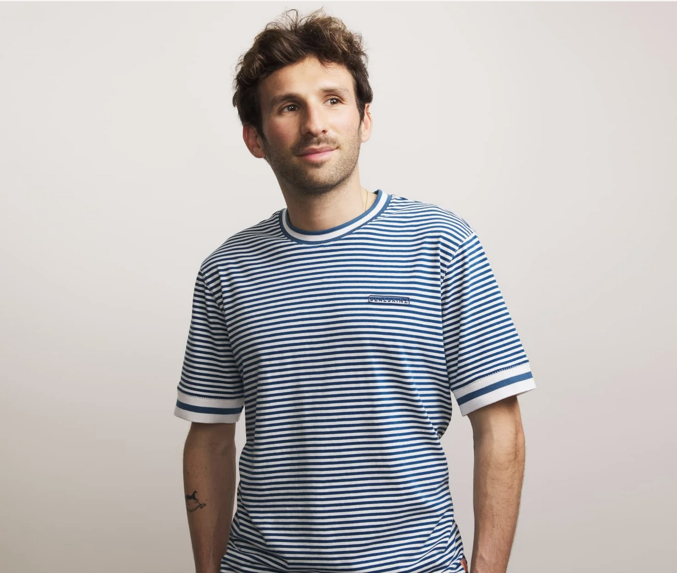 Male wearing a blue and white striped t-shirt