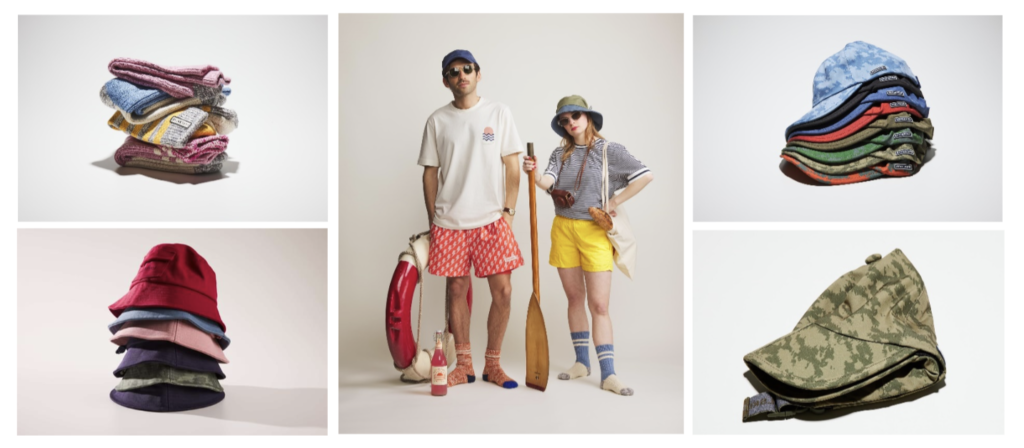 Couple in fashionable outdoor gear posing with a paddle and outdoor equipment
