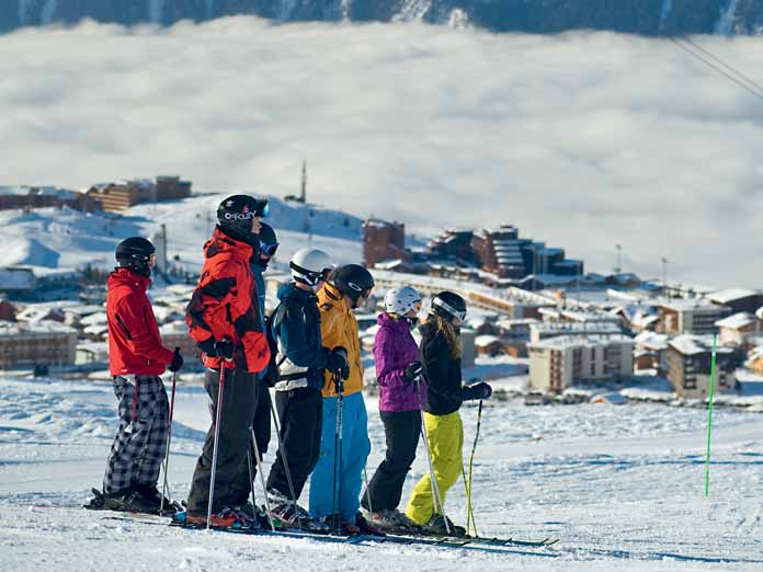 Family Ski holiday Family in group learning skiing in France